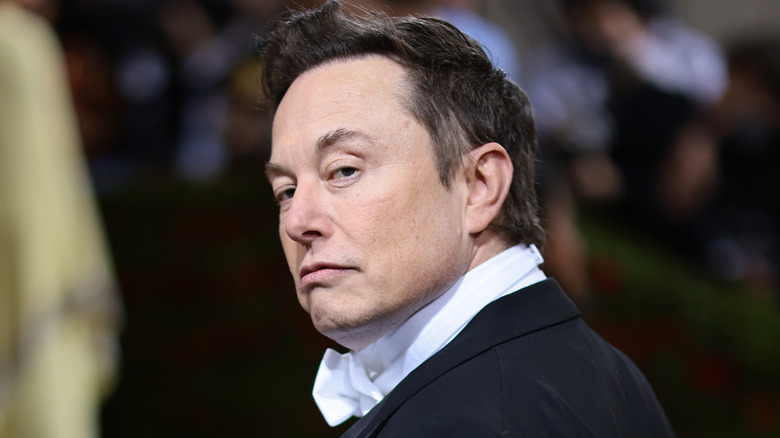 Elon Musk looking over his shoulder