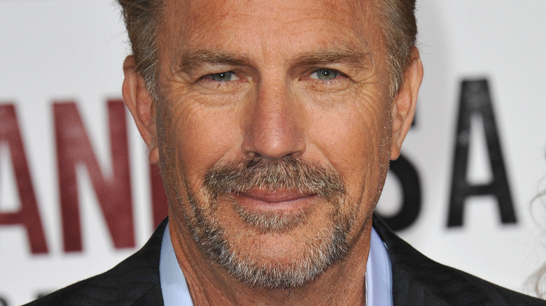 Kevin Costner poses in a suit in 2015.