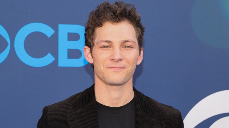 Dressed in all black, Montana Jordan squints his eyes and looks at the camera.