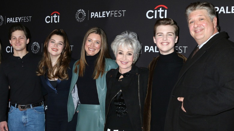 The cast members of "Young Sheldon" stand closely in line while smiling at the camera.