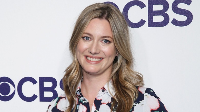 Dressed in a floral number, Zoe Perry tilts her head to side and sports a wide smile.