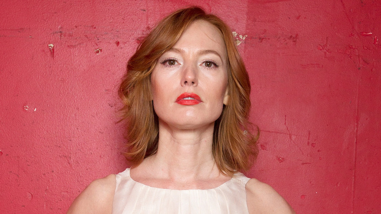 Alicia Witt with her arms out