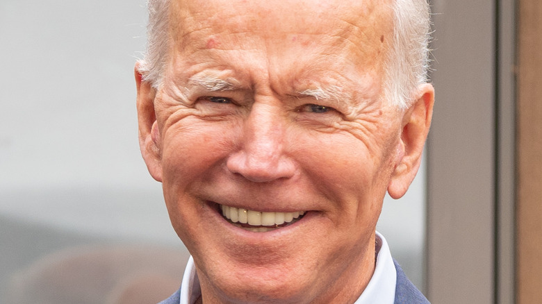 Joe Biden smiles at a conference