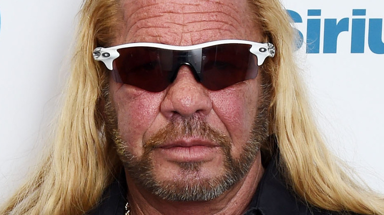 Dog the Bounty Hunter poses sunglasses