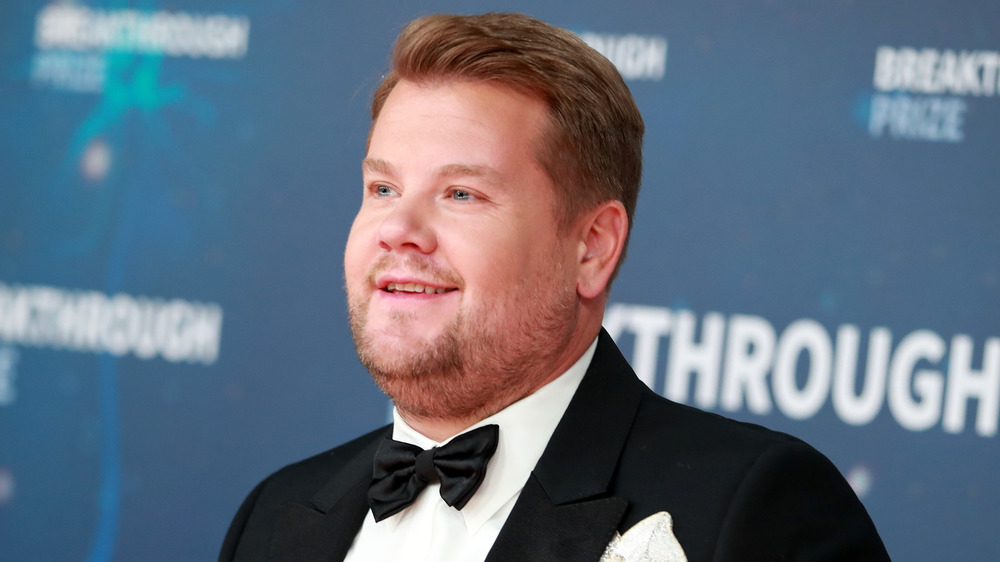 James Corden wears a bowtie as he poses at an event
