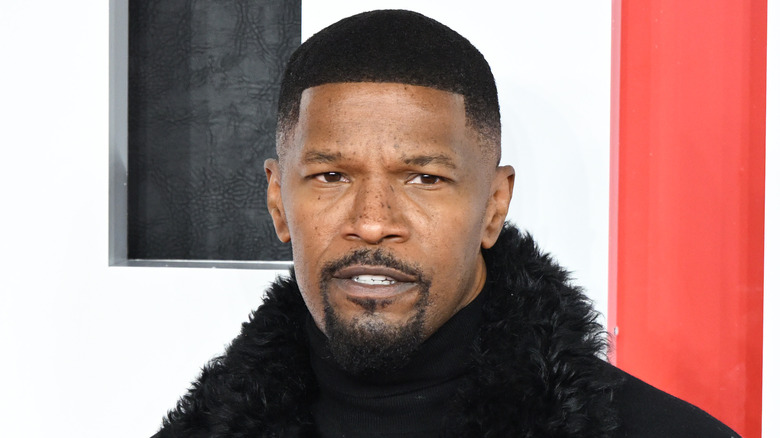 Jamie Foxx posing in a black jacket