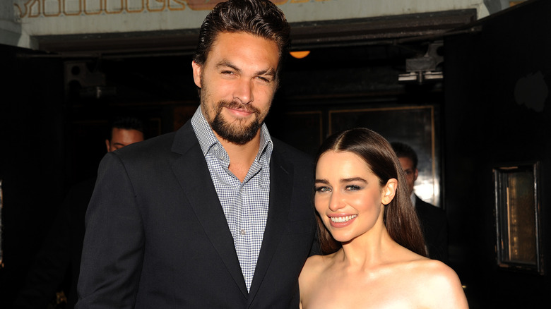 Jason Momoa and Emilia Clarke posing in 2013