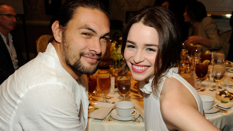 Jason Momoa and Emilia Clarke smiling in 2012