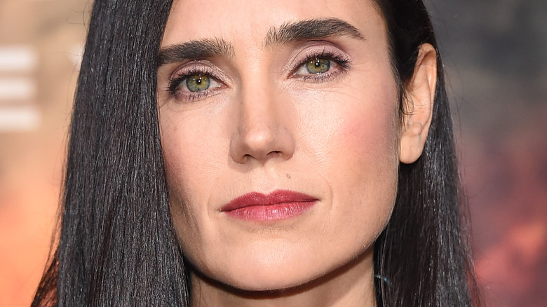 Jennifer Connelly poses in reddish lipstick.