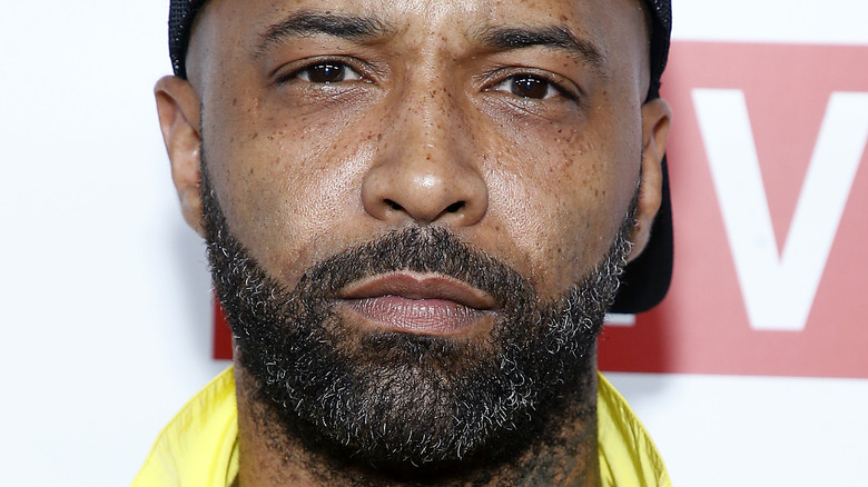 Joe Budden wearing black hat