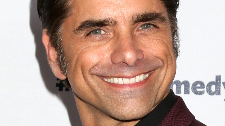 John Stamos grinning big