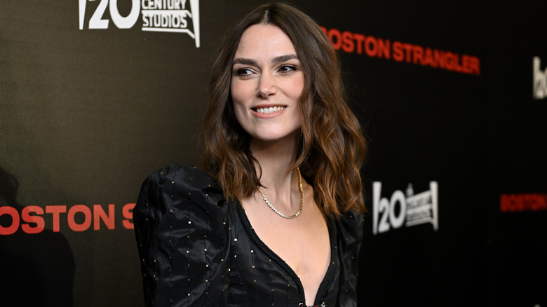 Keira Knightley smiling in low cut dress