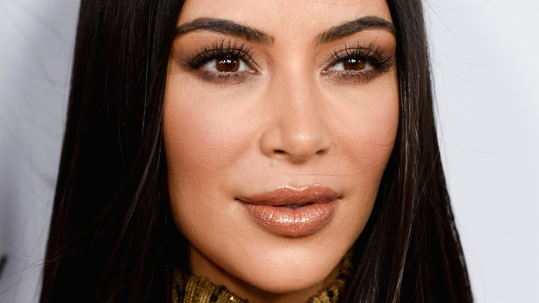 Kim Kardashian smiling and wearing lipgloss