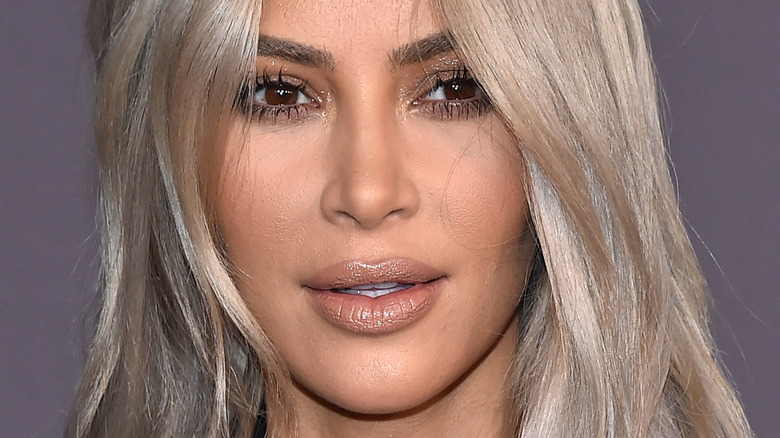 Kim Kardashian smiling with blonde hair