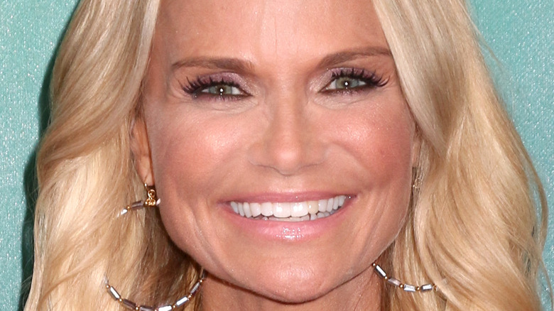 Kristin Chenoweth smiles wearing hoops