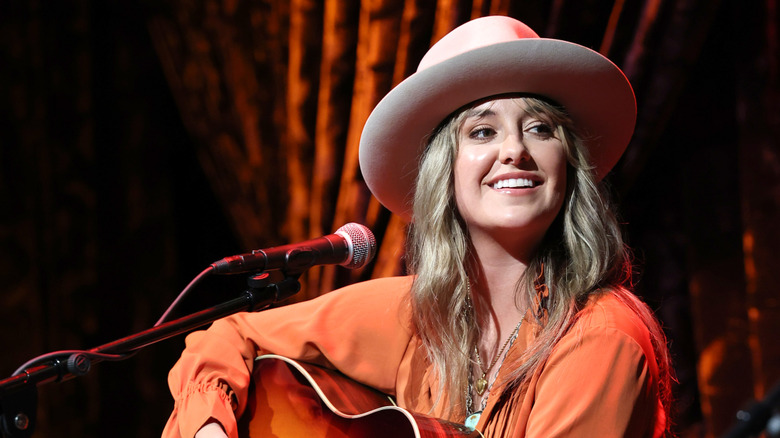 Lainey Wilson performs on stage.