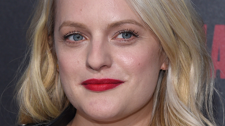 Elisabeth Moss poses in red lipstick.