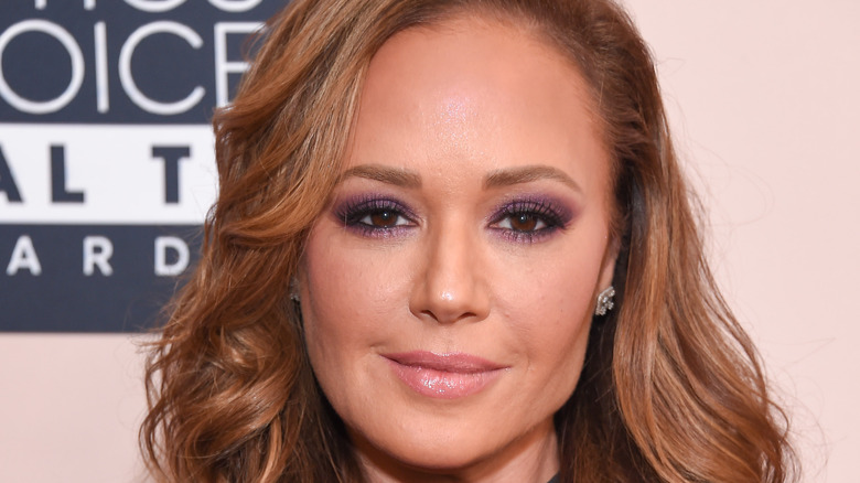 Leah Remini smiles on the red carpet