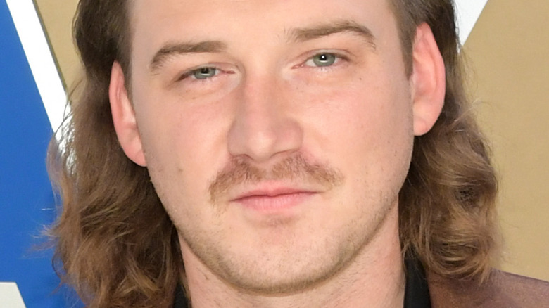 Morgan Wallen smirking on the red carpet