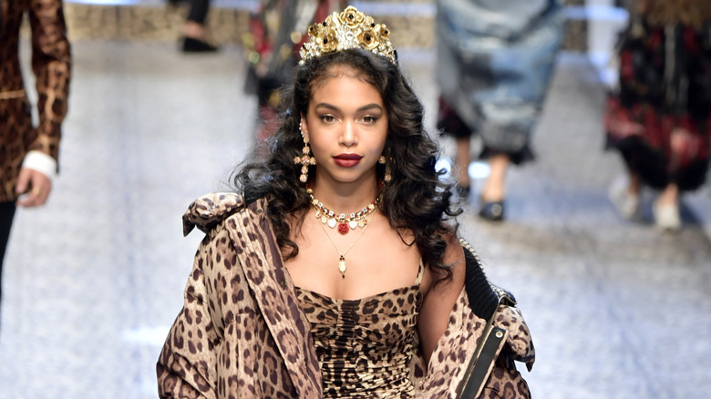 Lori Harvey walking on a runway as a model