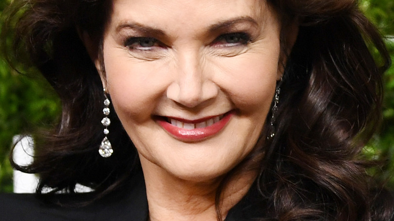 Lynda Carter smiling, wearing diamond earrings