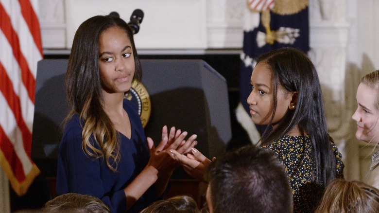 Malia and Sasha Obama looking away