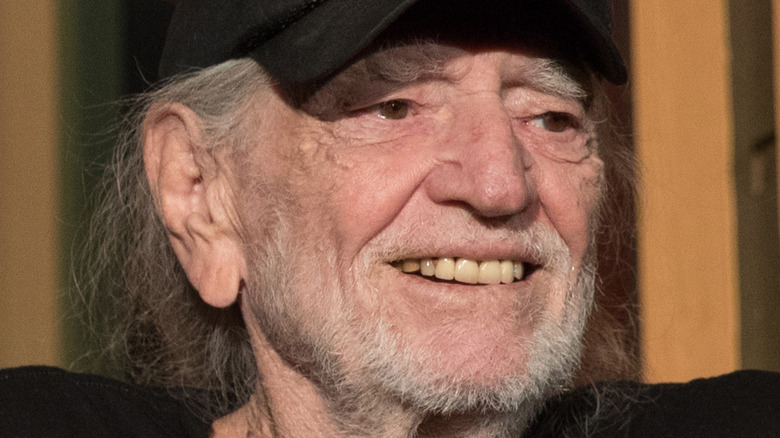Willie Nelson sitting with a hat on