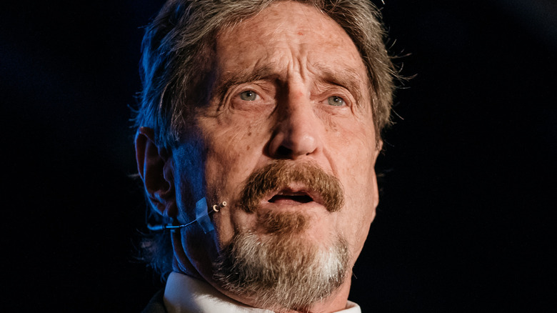 John McAfee speaks on stage