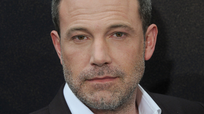 Ben Affleck poses in a brown suit.