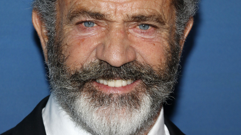 Mel Gibson with beard smiling at camera