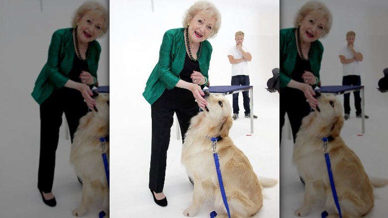 Betty White in 2012 with a Golden Retriever