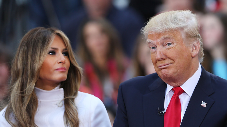 Melania Trump looking at a shrugging Donald Trump