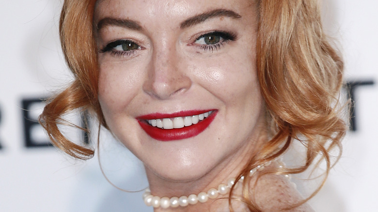 Lindsay Lohan curly red hair smiling bright red lip