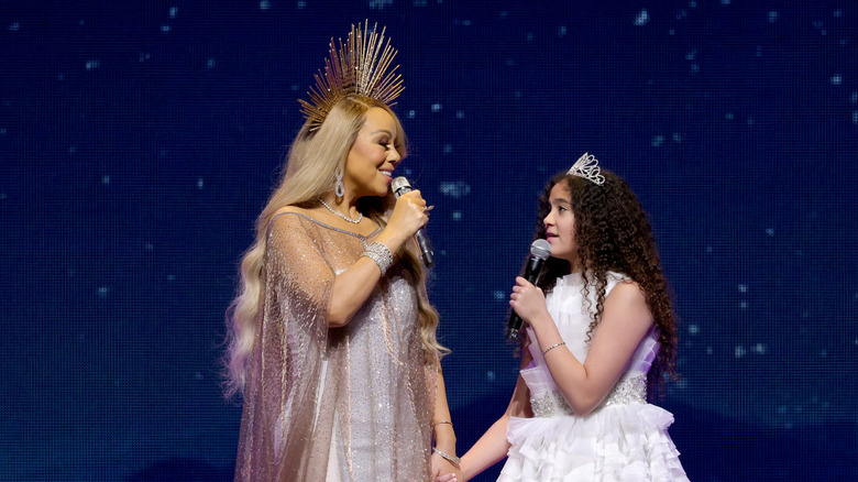 Mariah Carey performing onstage with Monroe Cannon
