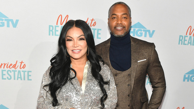 Egypt Sherrod and Mike Jackson posing at a 'Married to Real Estate' event.