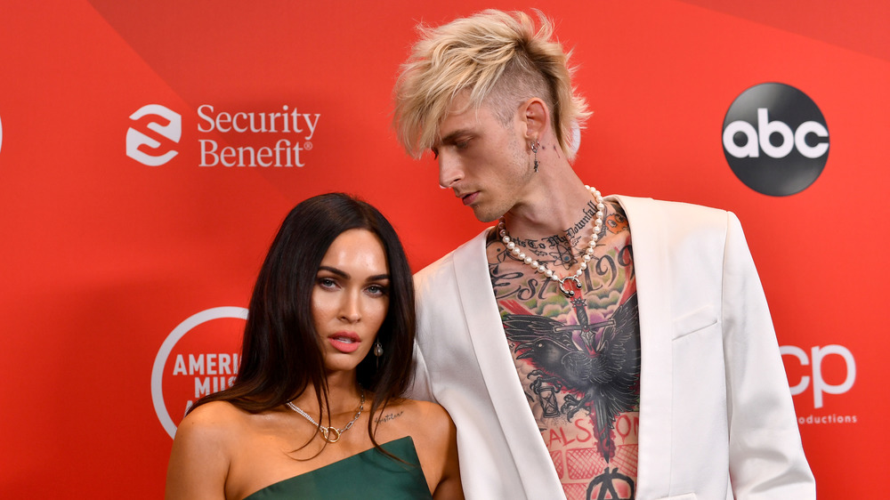 Megan Fox and Machine Gun Kelly posing for cameras at the 2020 American Music Awards