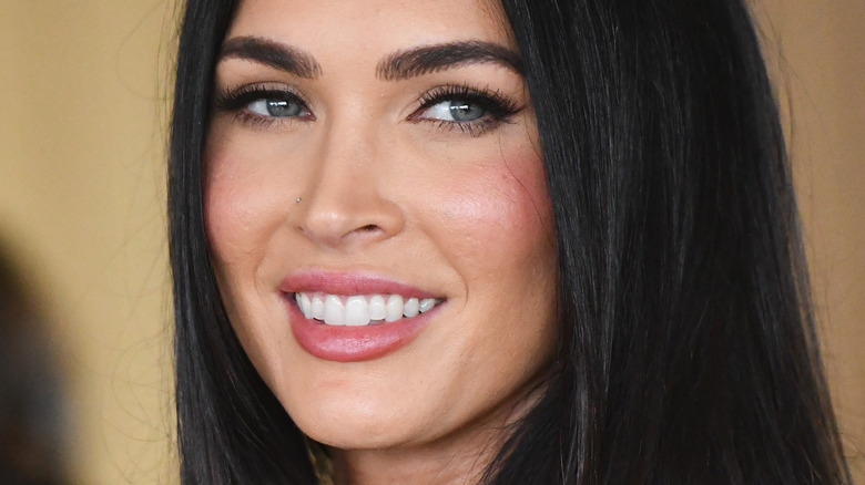 Megan Fox looks to side smiling