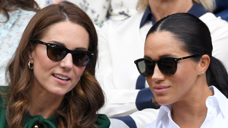 Kate Middleton leaning in to Meghan Markle