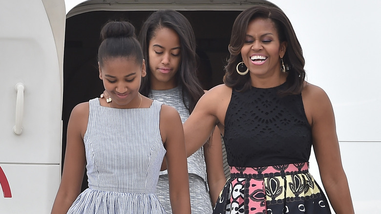 Malia, Michelle, and Sasha Obama exiting plane