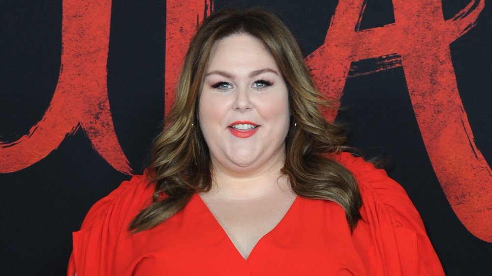 Chrissy Metz in a red dress, smiling at the Mulan premiere