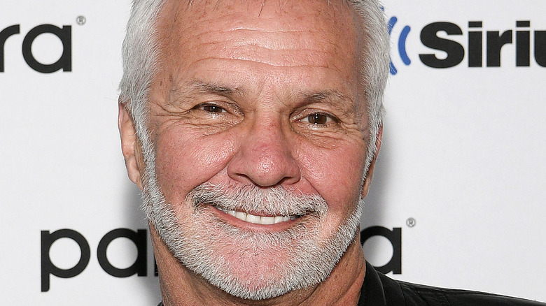 Below Deck's Captain Lee smiling gray beard and hair