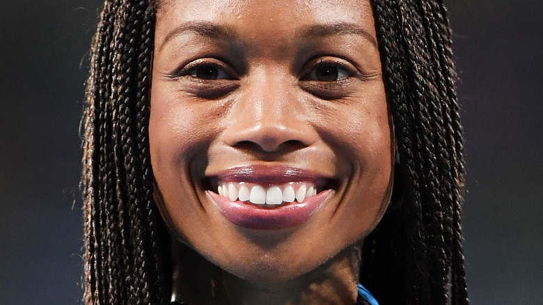 Allyson Felix, smiling, on the track field, 2021 photo