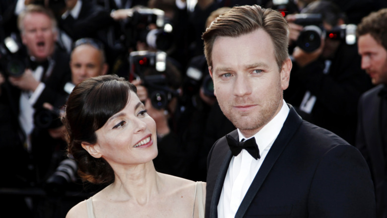Eve Mavarakis looks at Ewan McGregor as they pose for cameras