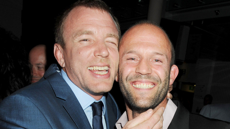 Jason Statham smiling with Guy Ritchie