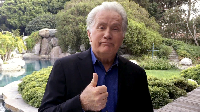 Martin Sheen giving thumbs-up in a garden