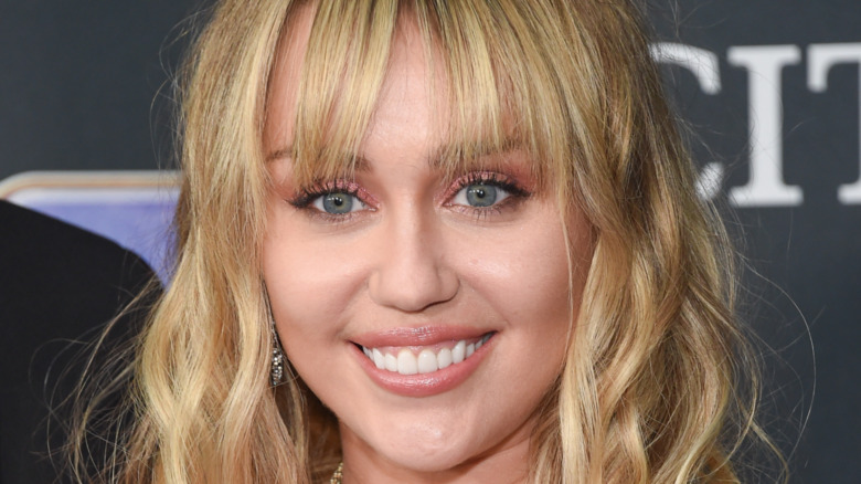 Miley Cyrus smiling on the red carpet