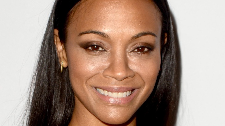 Zoe Saldana flashes a smile on the red carpet