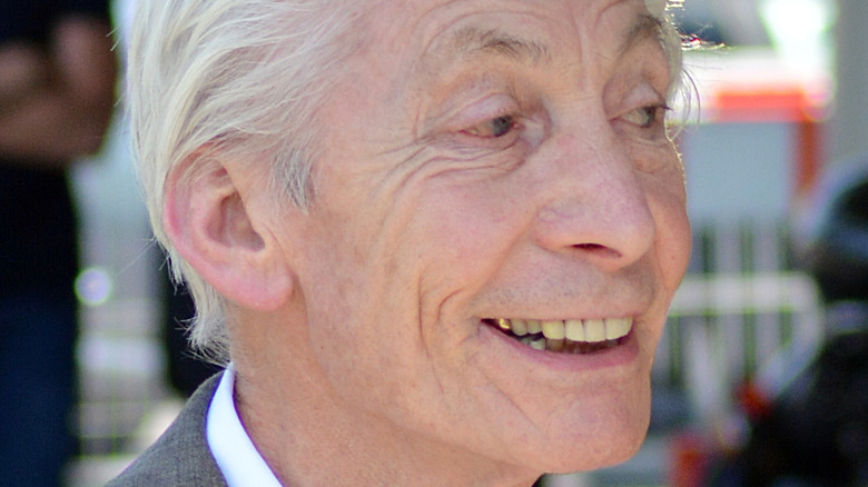 Charlie Watts smiles at an event