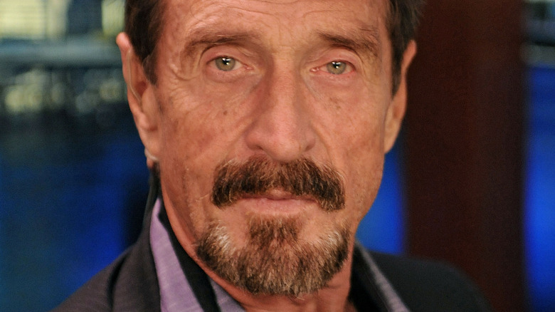 John McAfee poses for a photograph