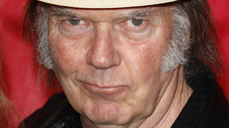 Neil Young poses in a hat